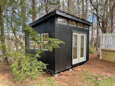 shed between trees