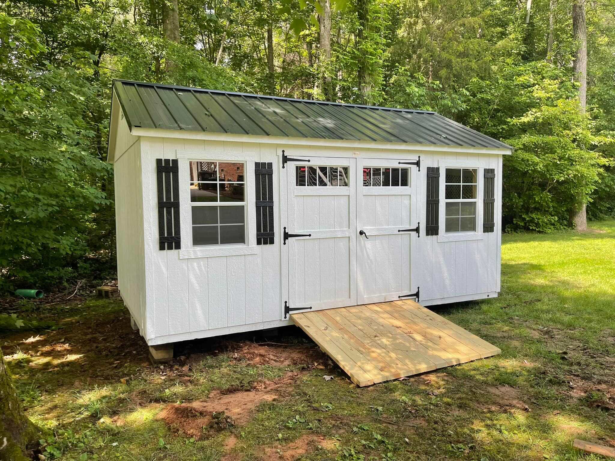 attractive shed with ramp black roof white trim