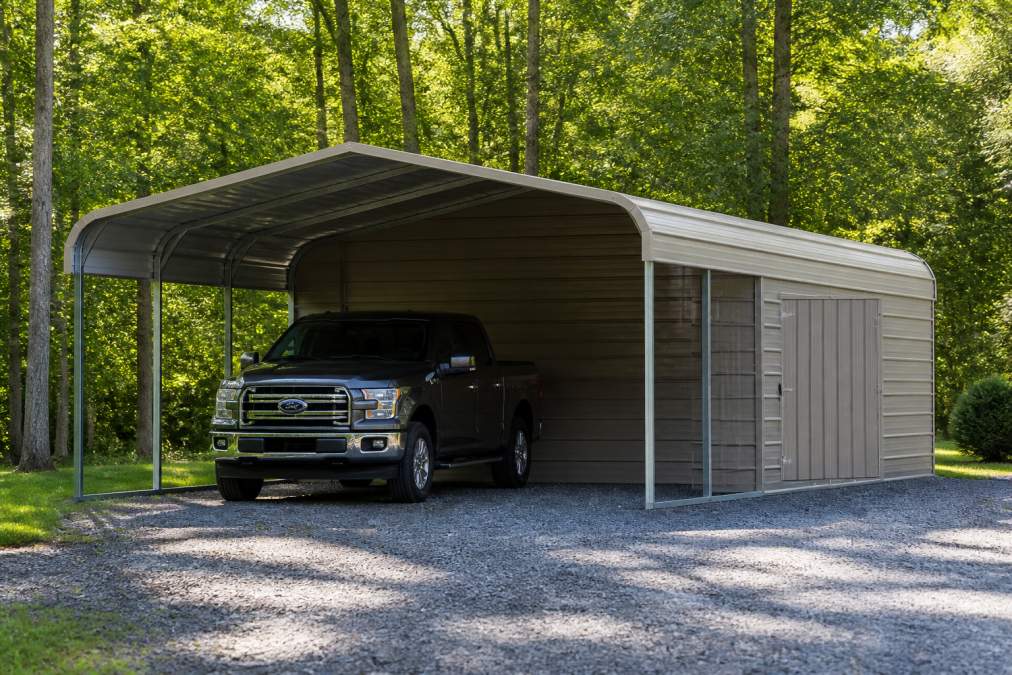 Residential property with a metal carport-shed combo structure protecting a parked vehicle on one side and featuring a lockable storage section on the other, demonstrating dual functionality in a home driveway setting