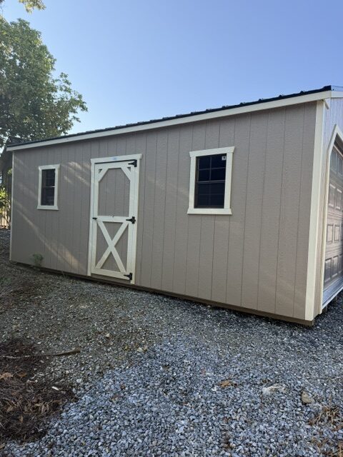 S26005 12x20x8 Classic Cottage in Buckskin and almond trim, 40 Year black metal roof, upgraded floor to 12″OC, 9×7 OH Garage door Brown, 2) 18×27 Windows, Alum ramp, and 4′ Loft
