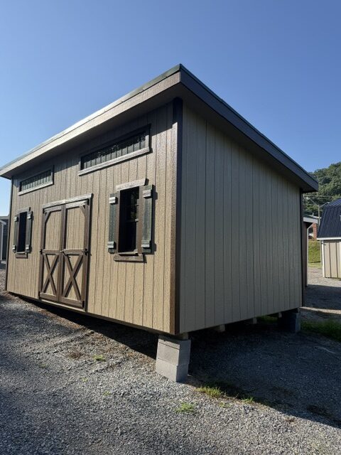 S25346 12x20x8 Classic Studio in Buckskin and Brown with Green shutters, 40 Year metal roof in green, insulated floor, 2) 6′ Transoms, 2′ Workbench, 2) 18×36 recessed windows and a 6′ Double Door