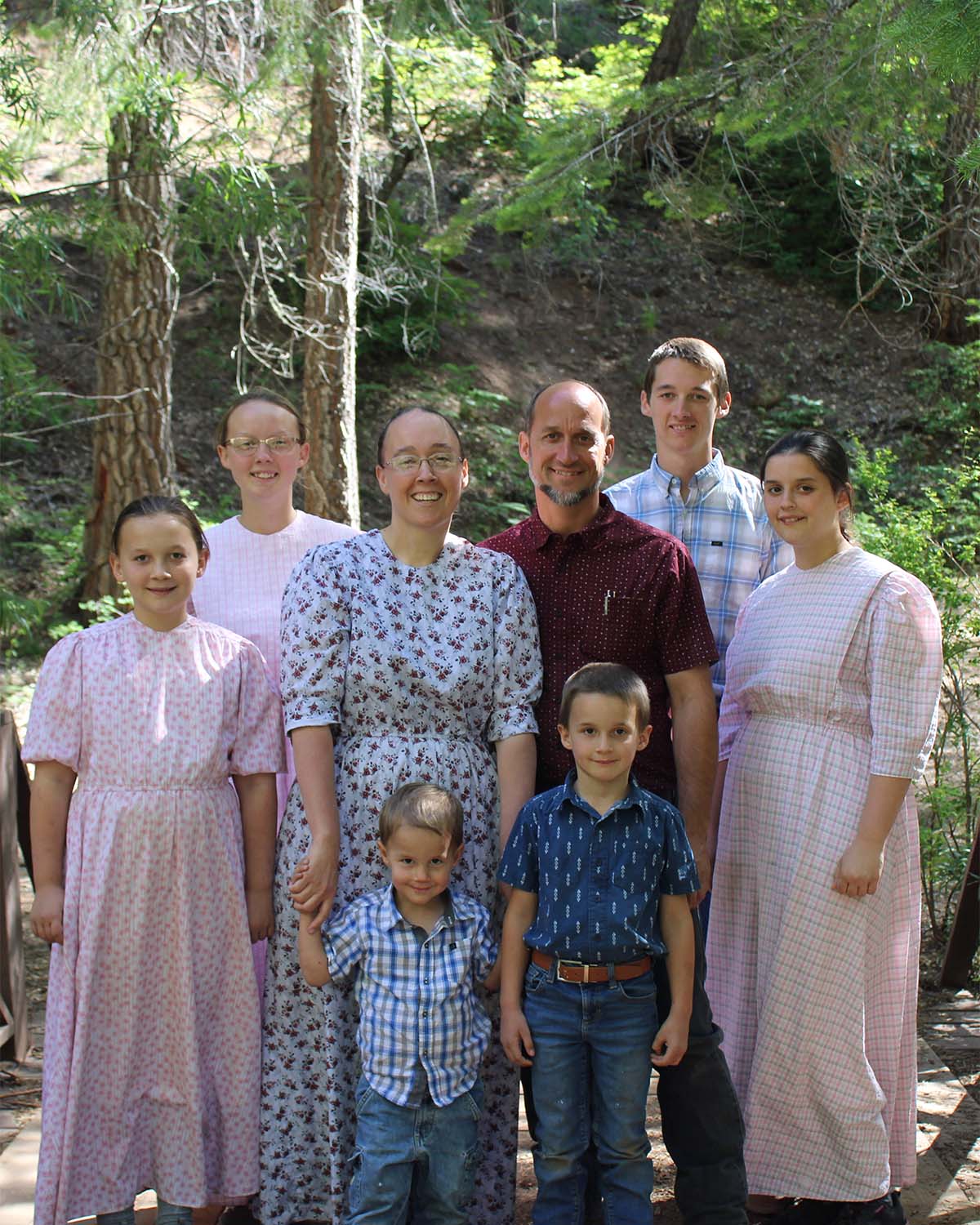 Photo of Nate and his family standing on a bridge.